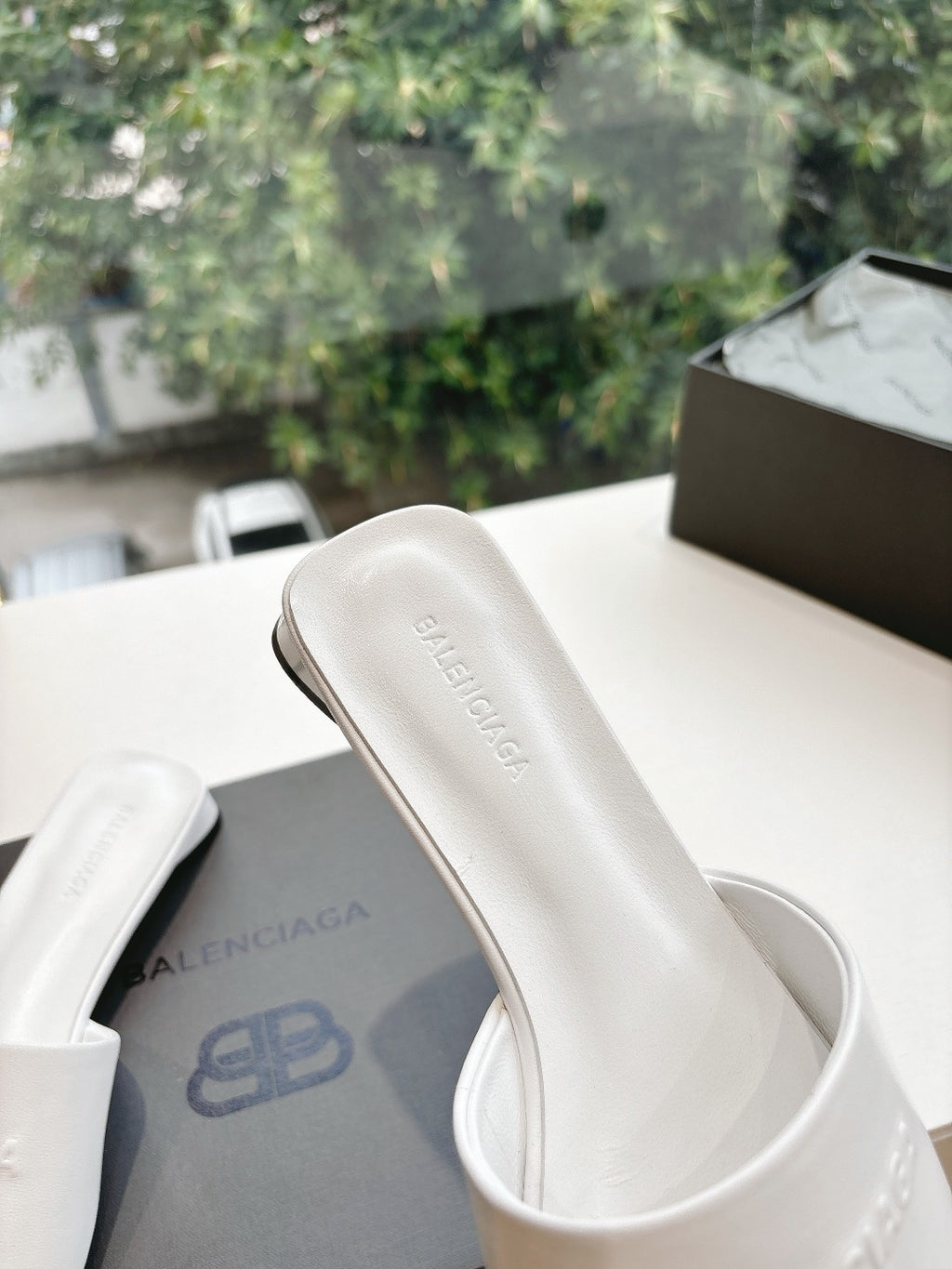 Balenciaga women's white slide sandal with 'BALENCIAGA' logo on strap