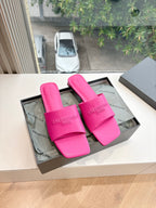 Pink Balenciaga slide sandals with wide logo straps, open toe.