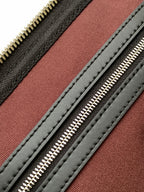 Monogram duffel bag interior lining with red panel and black stitched edges