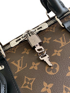 Monogram duffel bag close-up of zipper track, hardware, and key rings