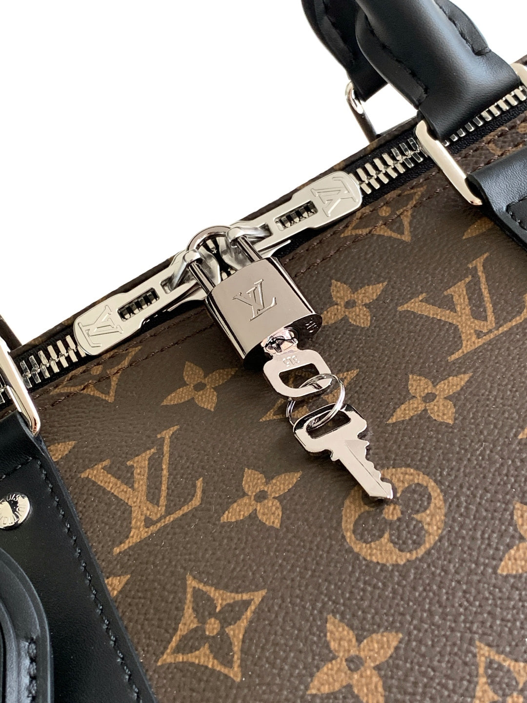 Monogram duffel bag close-up of zipper track, hardware, and key rings