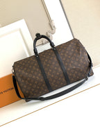 Monogram duffel bag with black handles and shoulder strap