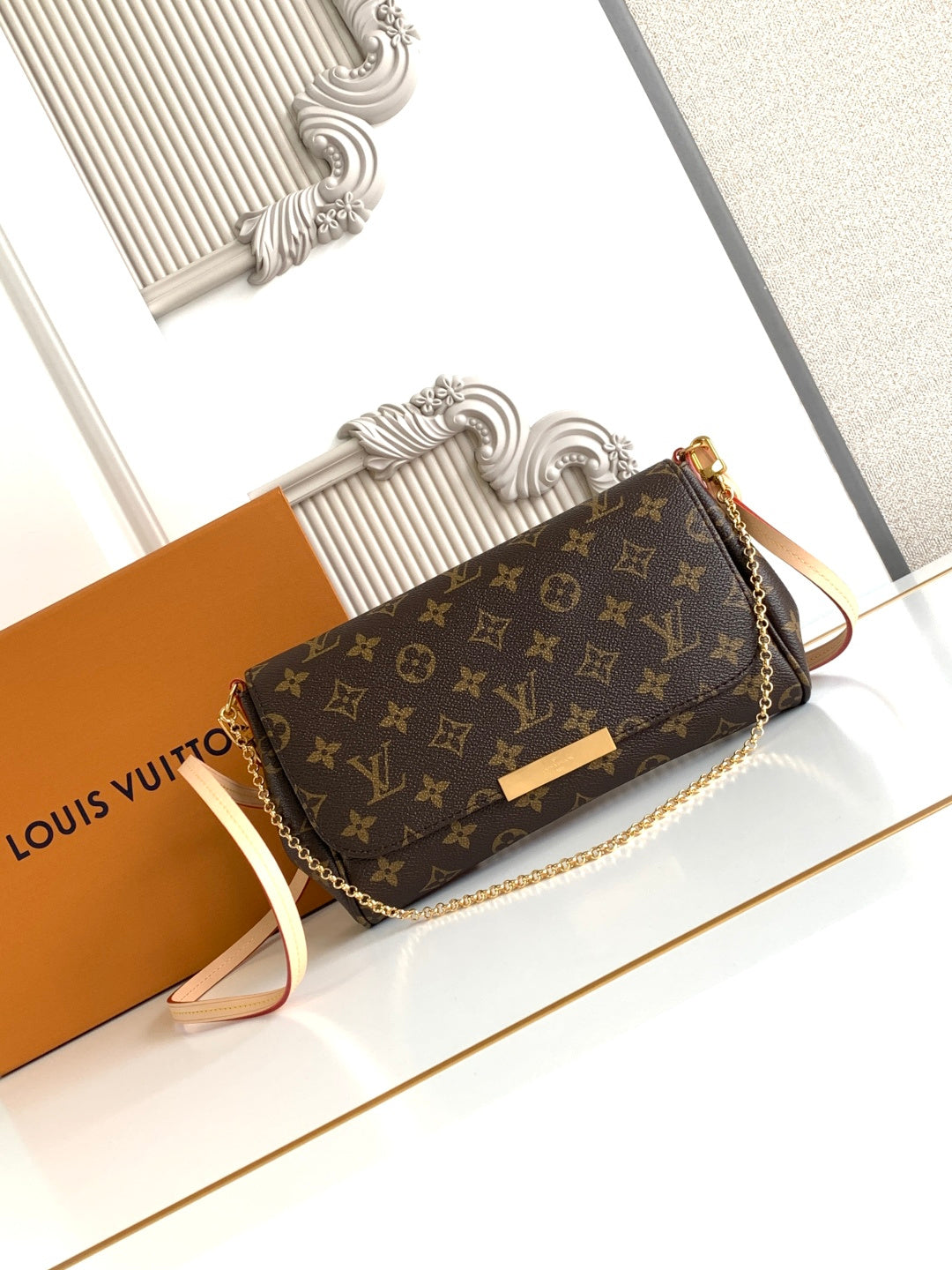 Louis Vuitton monogram crossbody bag, flap front, gold clasp, chain strap, brown canvas.