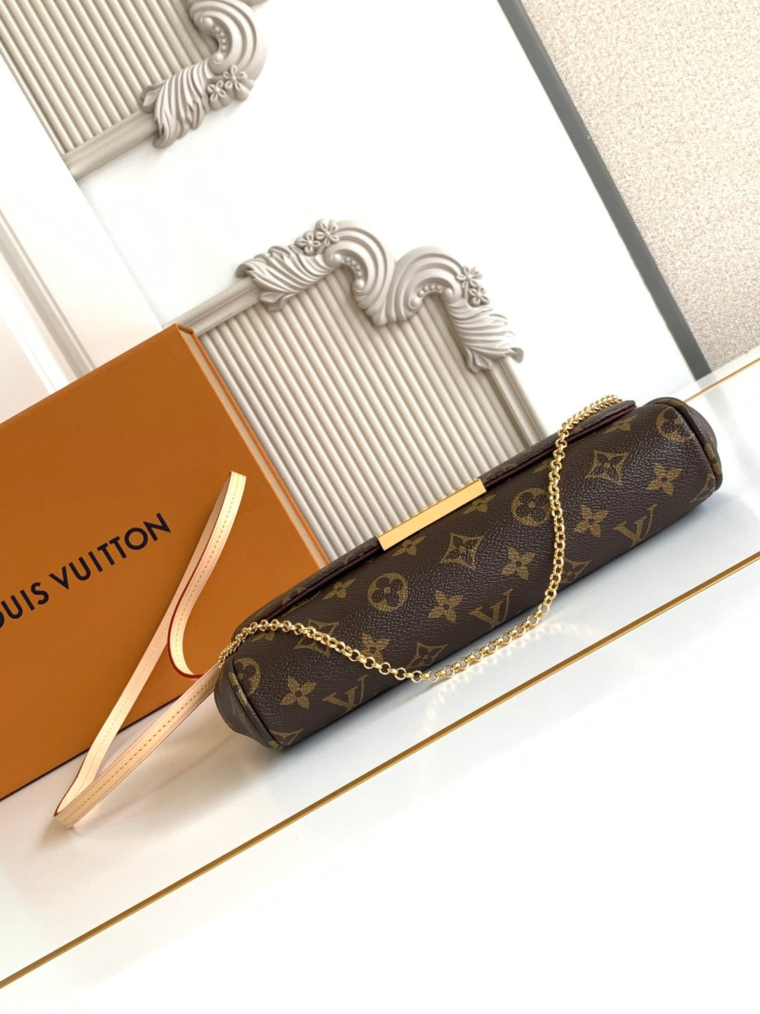 Louis Vuitton monogram shoulder bag, long chain strap, gold clasp, brown canvas body.