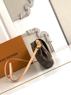 Louis Vuitton monogram crossbody bag with gold clasp, chain strap, brown and tan accents.
