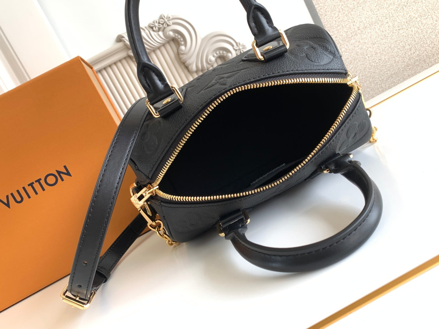 Louis Vuitton black handbag with open zip top and crossbody strap