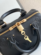 Louis Vuitton black leather handbag zipper detail with gold hardware