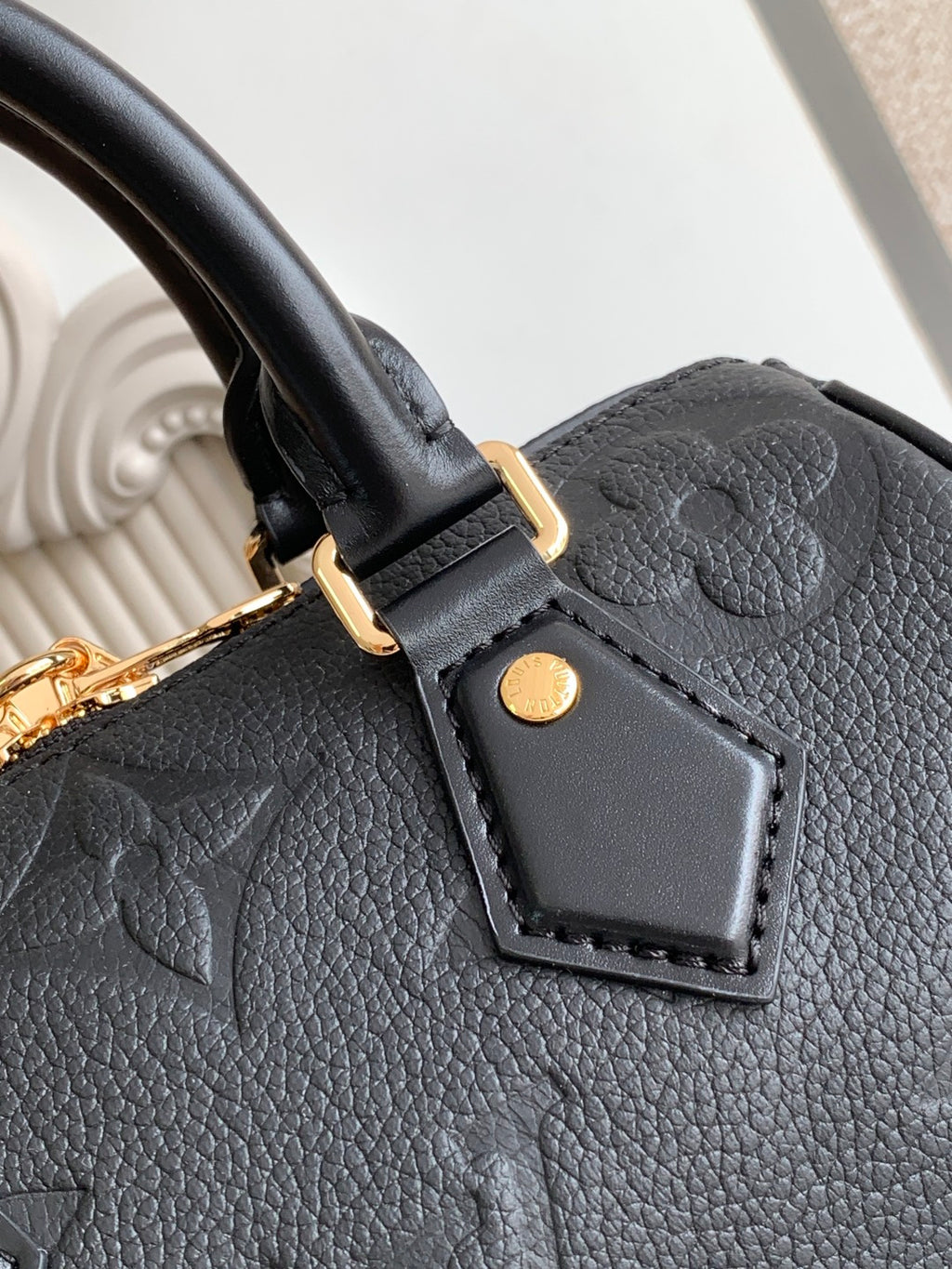 Louis Vuitton black leather handbag front strap tab with gold button