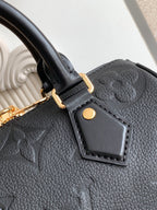 Louis Vuitton black leather handbag front strap tab with gold button