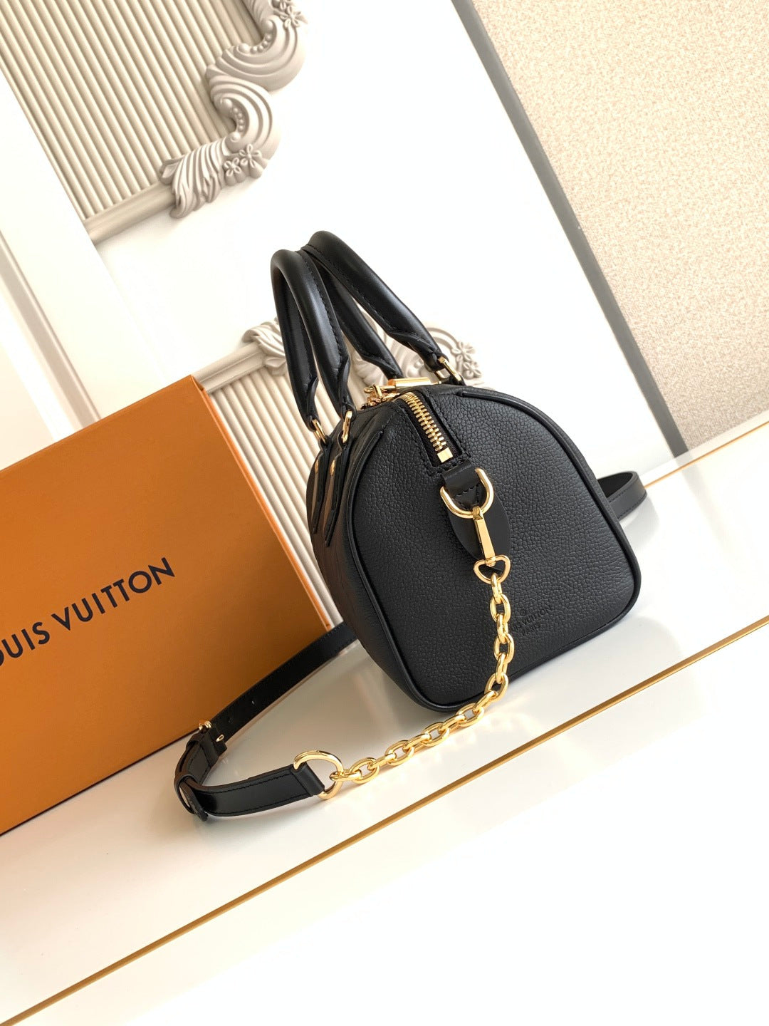 Louis Vuitton black embossed handbag with chain shoulder strap and curved handles