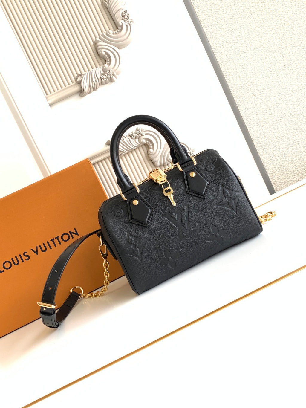 Louis Vuitton black embossed mini handbag with top handles and gold hardware