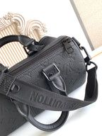 Louis Vuitton monogram crossbody bag, black textured leather with front zipper pocket.