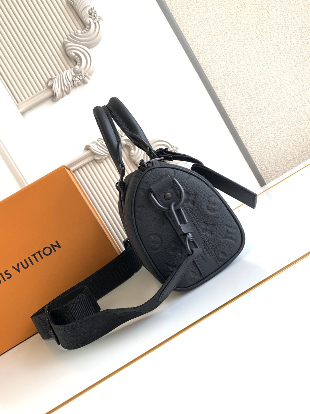 Louis Vuitton monogram crossbody bag, black with zipped top and strap.