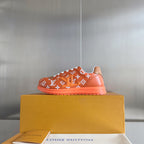 Orange monogram sneaker with white laces, white collar, on box