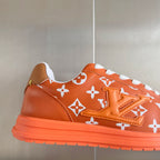 Orange monogram sneaker upper with white laces and thick orange rubber sole
