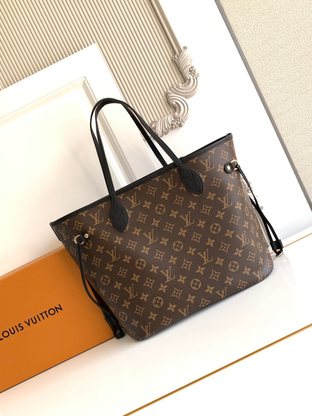 Louis Vuitton monogram tote bag with black leather trim and top handles