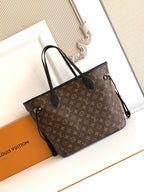 Louis Vuitton monogram tote bag with black leather trim and top handles