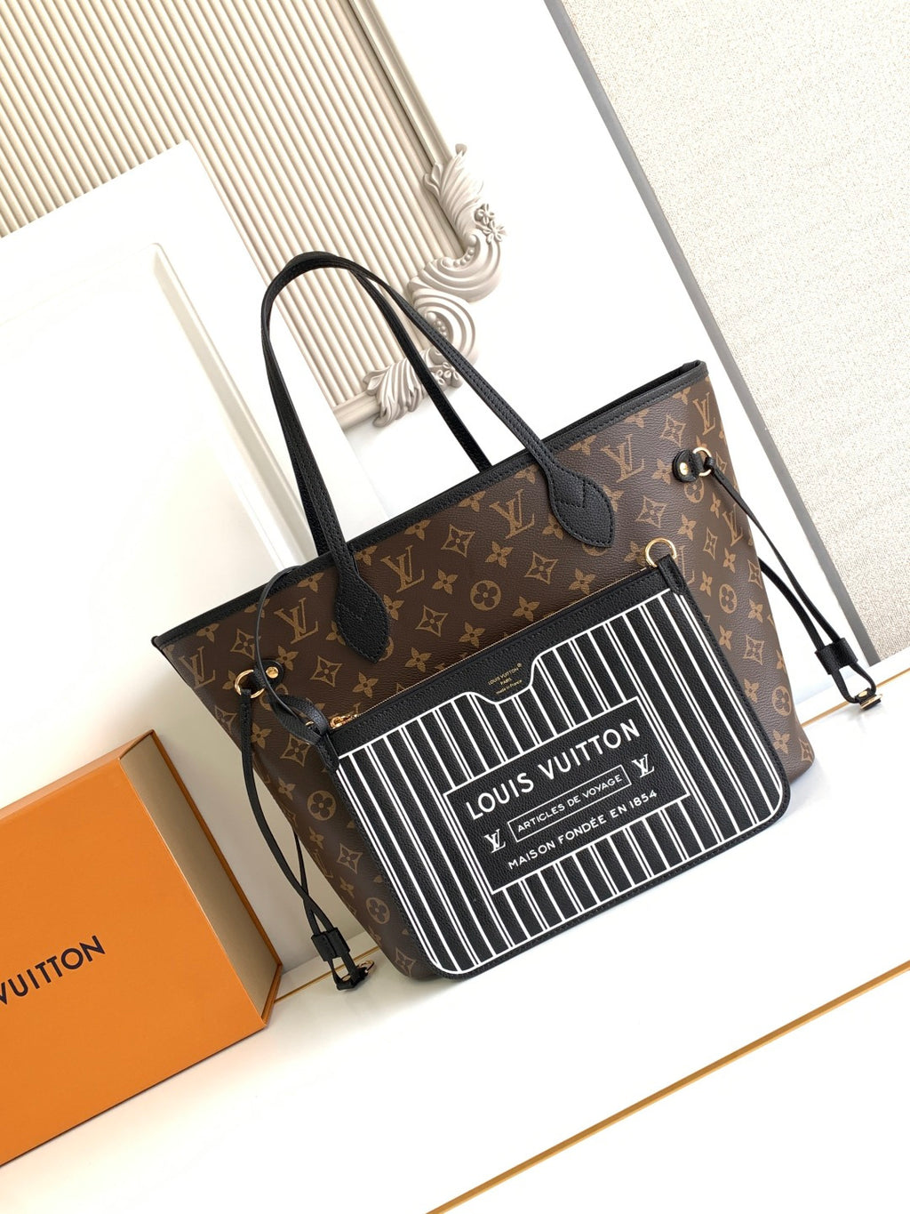 Louis Vuitton monogram tote bag with black handles and zip top; front barcode-style panel