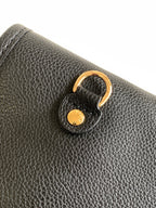 Louis Vuitton textured leather bag corner with gold-tone key ring pull