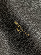 Louis Vuitton Paris logo on black textured leather with gold lettering