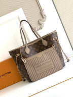 Brown monogram tote bag with light striped front panel, top handles, and zipper
