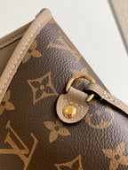 Brown monogram handbag close-up with gold clasp on textured leather strap