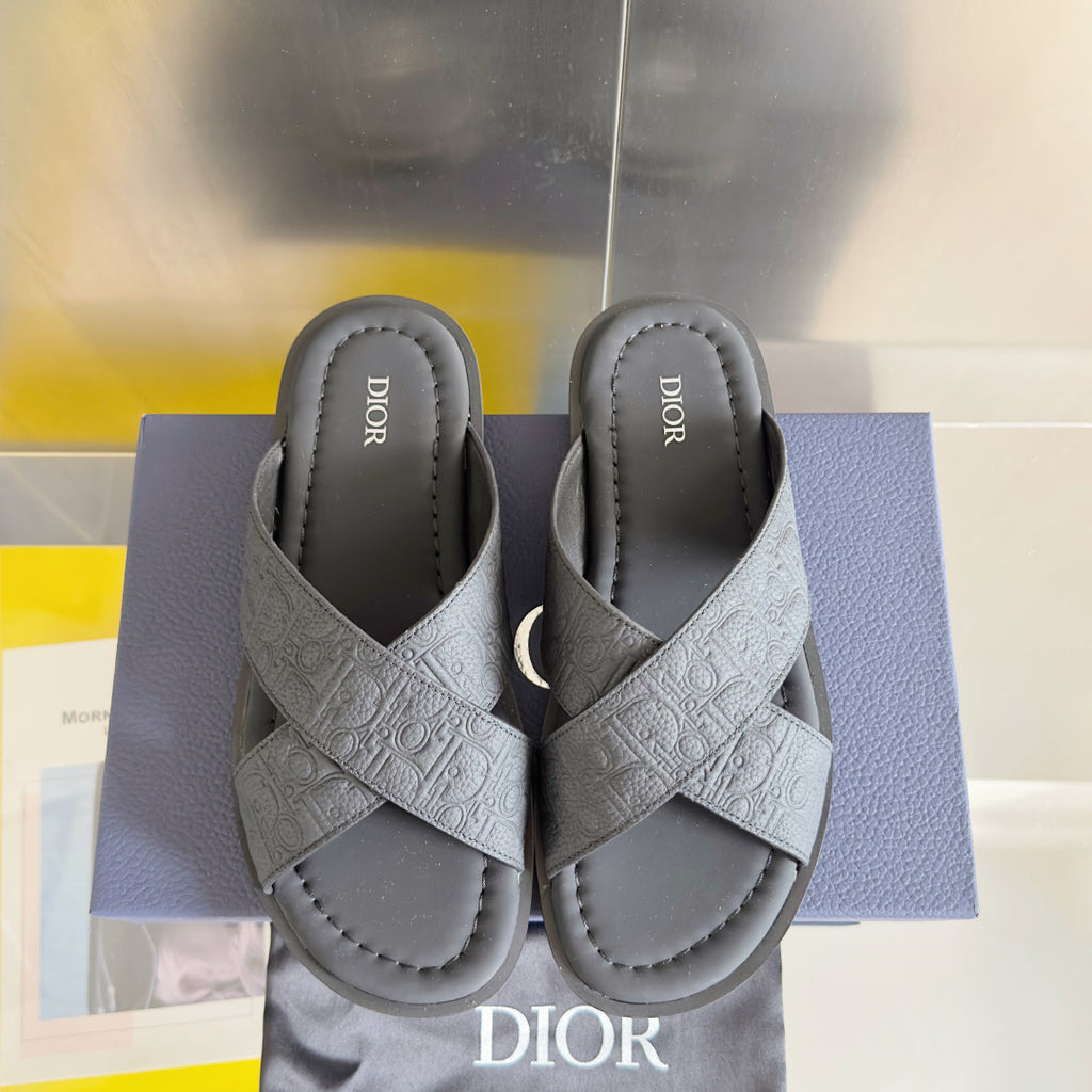 Dior unisex slide sandals in light gray, pair view with embossed crisscross straps