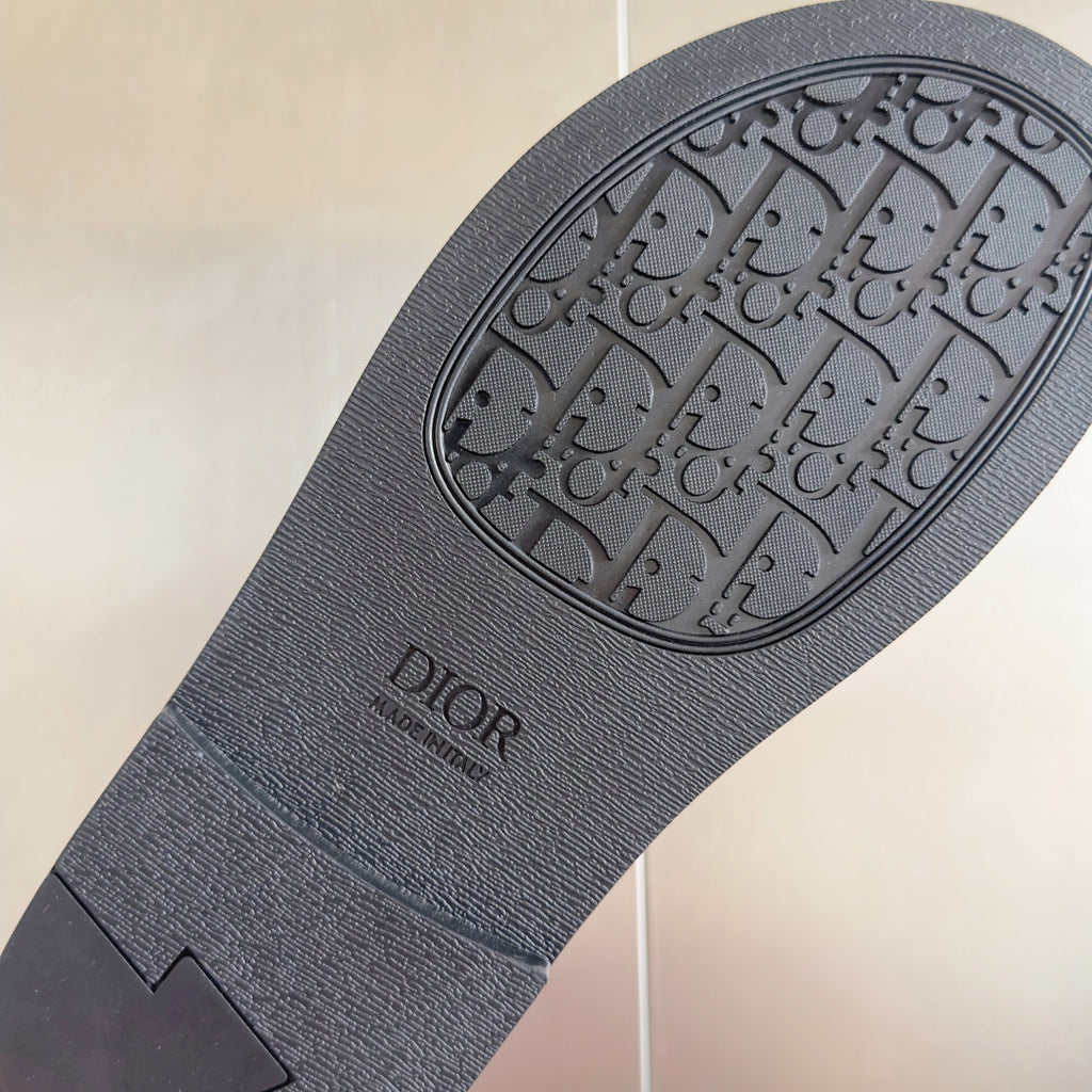 Dior unisex slide sandal outsole in dark gray with embossed logo pattern