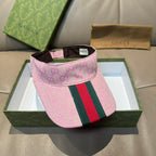 Pink Gucci visor cap with GG pattern and green-red-and-green web stripe