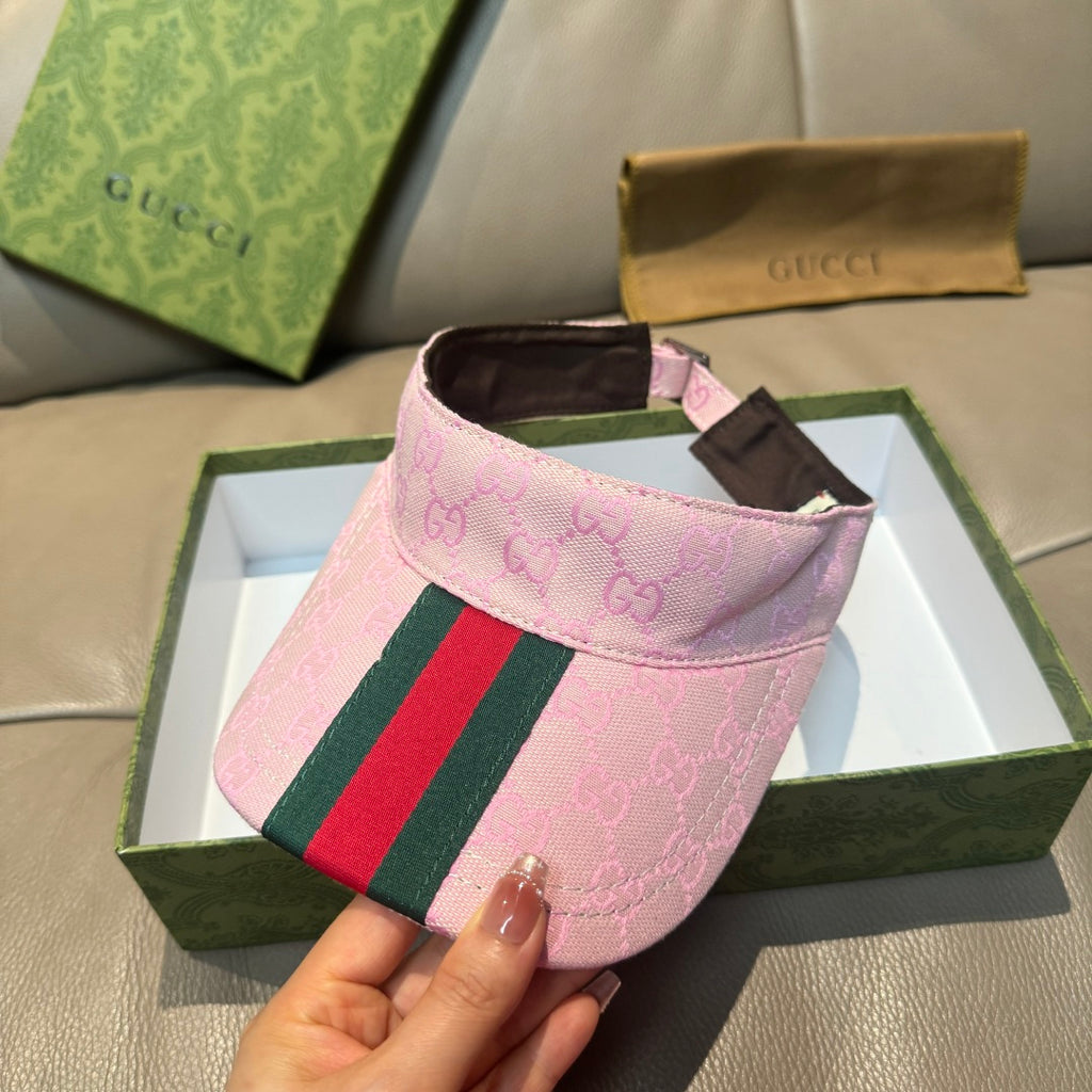 Pink Gucci visor cap with GG monogram and green-red web stripe detail