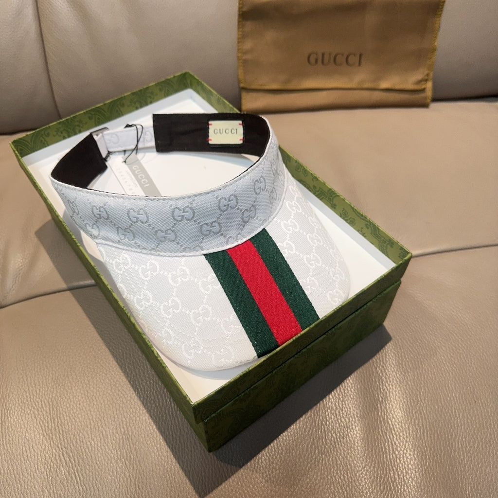 Gucci visor cap with GG monogram, green red web stripe, light blue front view