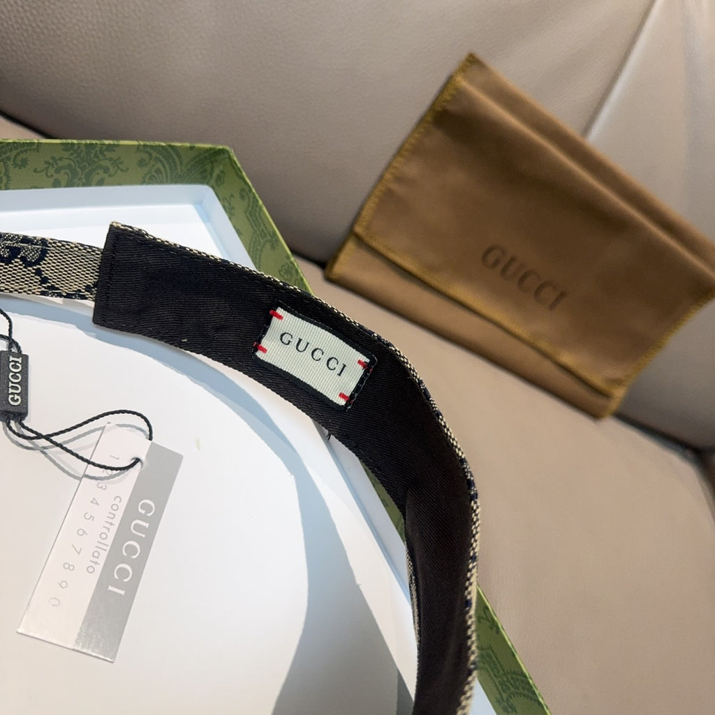 Gucci cap label on black interior strap, GG canvas exterior with red accent