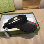 Gucci visor cap on box display: dark GG pattern with green and red stripe front