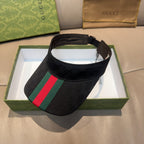 Gucci visor cap in dark GG fabric with green and red striped front panel