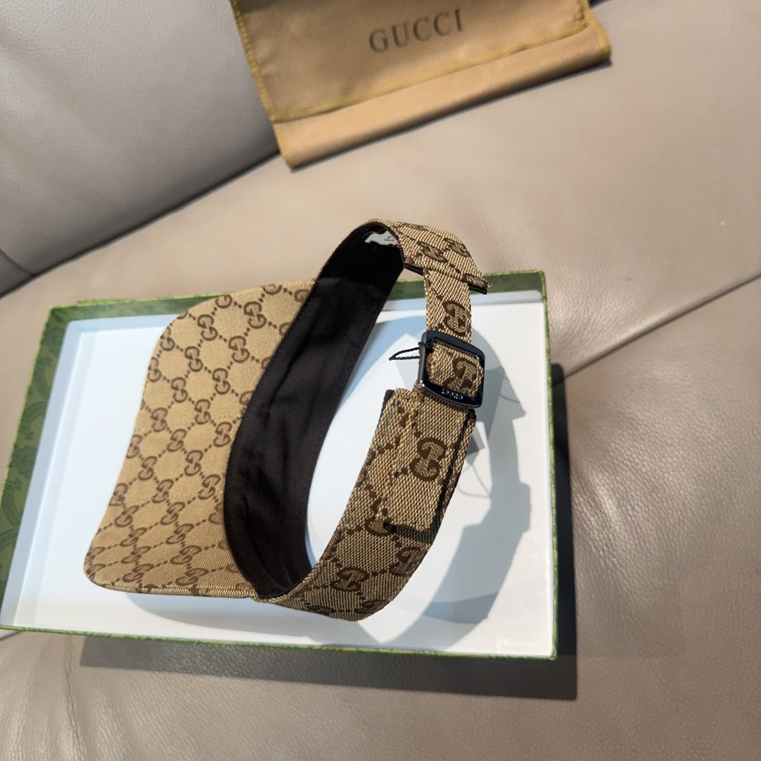 Gucci GG canvas visor cap with green and red web stripe, buckle detail on strap