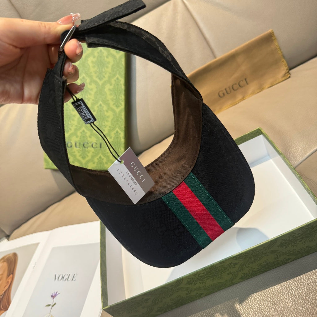 Gucci visor cap interior view, adjustable strap and brown leather trim on dark monogram.