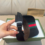 Gucci visor cap strap detail in dark canvas with buckle, showing green-red stripe panel.