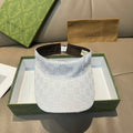 White GG-print visor cap with brown inner band and adjustable strap