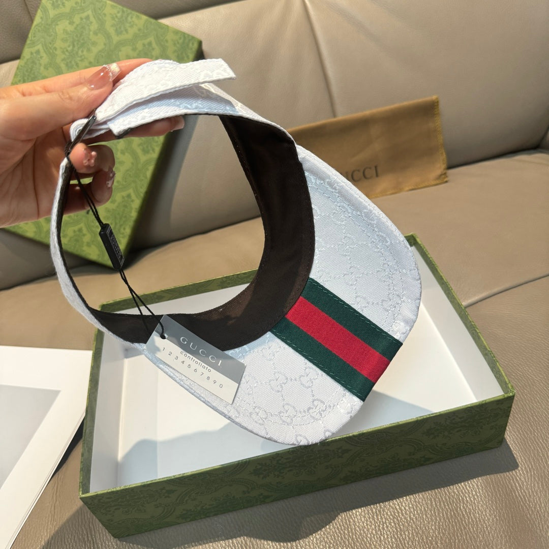White GG-print visor cap with green-red Web stripe and dark underside; hanging tag