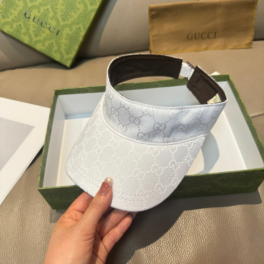 White GG-print visor cap angled view, brown inner band and adjustable strap