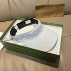 White GG-print visor cap with brown inner band visible