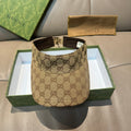 Brown GG monogram visor cap with black interior and adjustable strap