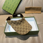 Brown GG monogram visor cap with black trim and adjustable strap