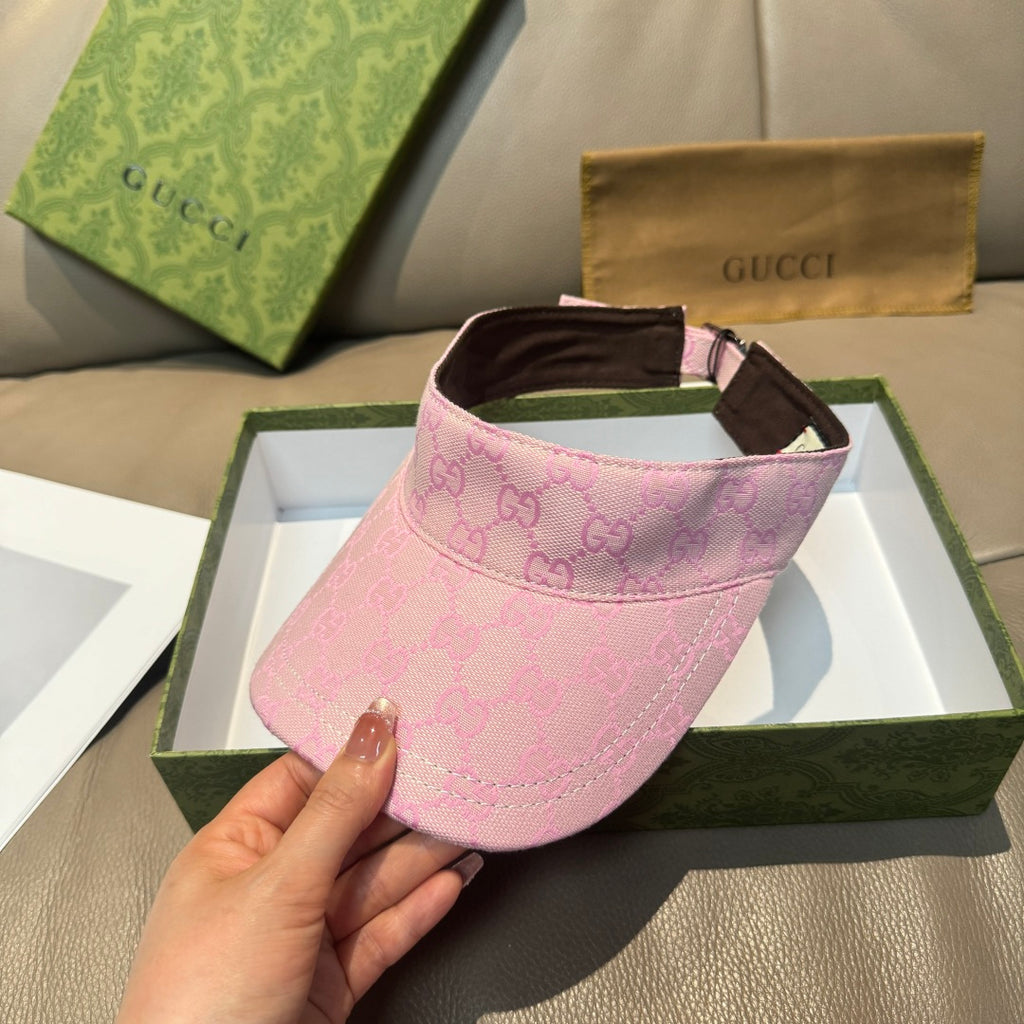 Pink visor cap with GG monogram print, brown brim, and adjustable strap