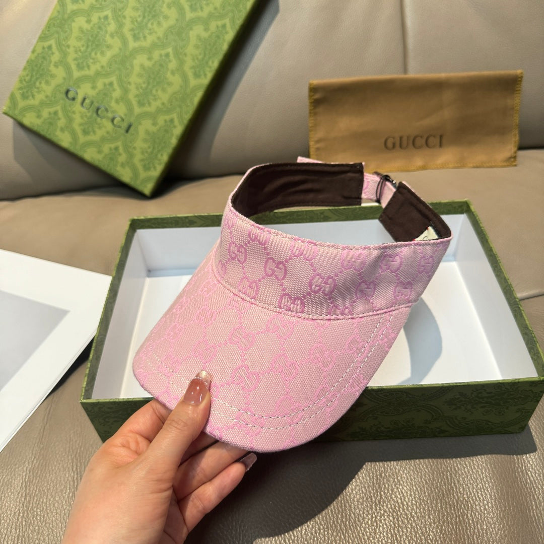 Pink visor cap with GG monogram print, brown brim, and adjustable strap