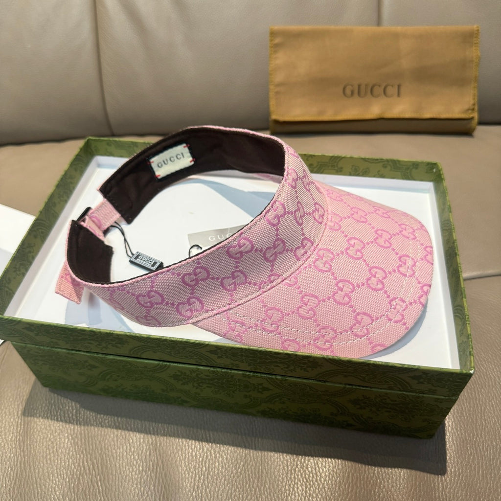 Pink GG visor cap with brown brim, green-red stripe, and interior tag