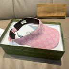 Pink GG visor cap with brown brim, green-red stripe, and interior tag