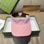 Pink GG-pattern visor cap with brown trim and adjustable strap