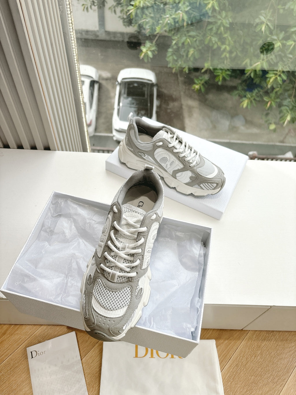 Women’s lace-up sneakers, light gray and white, with perforated panels and laces