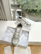 Women’s lace-up sneakers, light gray and white, with perforated panels and laces